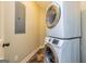 Well-organized laundry area features a modern, stacked washer and dryer unit and easy access to electrical panel at 410 Wicklow St, Tyrone, GA 30290