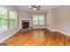 Cozy living room with a stone fireplace and hardwood floors at 410 Wicklow St, Tyrone, GA 30290