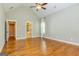 This primary bedroom shows a vaulted ceiling, wood floors, and a glimpse of the bathroom at 410 Wicklow St, Tyrone, GA 30290