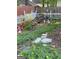 Backyard featuring a garden with flowers, stepping stones, and a white picket fence at 411 Sherrels Frd, Peachtree City, GA 30269