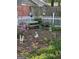 Backyard features a bench, garden art and lush landscaping at 411 Sherrels Frd, Peachtree City, GA 30269