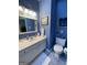 Well lit bathroom with white fixtures and blue walls at 411 Sherrels Frd, Peachtree City, GA 30269