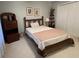 Bedroom showcasing a wooden bed frame alongside a traditional display case and built-in wardrobe at 411 Sherrels Frd, Peachtree City, GA 30269