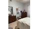 Cozy bedroom featuring warm-toned wooden dresser and decor, next to a patchwork quilt-covered bed and carpet at 411 Sherrels Frd, Peachtree City, GA 30269