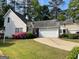Charming two-story home with landscaped yard and attached two-car garage at 411 Sherrels Frd, Peachtree City, GA 30269