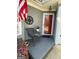Inviting front porch featuring a chair, flowers, and American flag for a welcoming entrance at 411 Sherrels Frd, Peachtree City, GA 30269