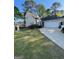 Traditional two-story home featuring a two-car garage, manicured lawn, and a welcoming driveway at 411 Sherrels Frd, Peachtree City, GA 30269