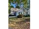 Charming one-story home with grey siding, complemented by well-maintained landscaping and flowering bushes at 411 Sherrels Frd, Peachtree City, GA 30269