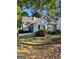 Charming one-story home with grey siding, complemented by well-maintained landscaping and flowering bushes at 411 Sherrels Frd, Peachtree City, GA 30269