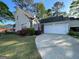 Traditional two-story home featuring a two-car garage, manicured lawn, and a welcoming driveway at 411 Sherrels Frd, Peachtree City, GA 30269