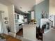 Open concept kitchen boasts white cabinets, a breakfast bar and is open to the living area at 411 Sherrels Frd, Peachtree City, GA 30269
