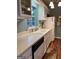 Well-lit kitchen features white cabinets, updated countertops, stainless steel appliances, and modern fixtures at 411 Sherrels Frd, Peachtree City, GA 30269