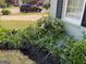 Beautiful landscaping with flowers and mulch near home's brick facade at 411 Sherrels Frd, Peachtree City, GA 30269