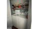 The laundry room features a washer, dryer, and overhead storage shelves at 411 Sherrels Frd, Peachtree City, GA 30269