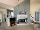 Inviting living room features a brick fireplace, neutral carpet, and a view of the kitchen at 411 Sherrels Frd, Peachtree City, GA 30269