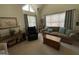 Cozy living room with plush seating, neutral carpet, and a bright window at 411 Sherrels Frd, Peachtree City, GA 30269