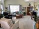 Bright living room with vaulted ceilings, neutral carpet, a large window, and comfortable seating at 411 Sherrels Frd, Peachtree City, GA 30269