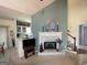 Inviting living room features a brick fireplace, neutral carpet, and a view of the kitchen at 411 Sherrels Frd, Peachtree City, GA 30269
