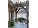 Covered patio with chairs, a sliding glass door, and well-maintained landscaping at 411 Sherrels Frd, Peachtree City, GA 30269