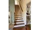 View of the staircase leading to the upper level and a doorway to a bedroom at 411 Sherrels Frd, Peachtree City, GA 30269
