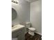 Neat bathroom featuring a vanity with integrated sink, round mirror, and standard toilet at 30 Laurel Way, Covington, GA 30016