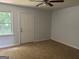Clean, carpeted room features a window and door leading to the backyard at 30 Laurel Way, Covington, GA 30016