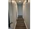 Clean hallway with gray walls and wood-look floors, providing access to different areas of the home at 30 Laurel Way, Covington, GA 30016