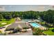 Aerial photo showcasing a neighborhood pool, tennis courts, and golf course amidst a green backdrop at 5133 Woodmond Dr, Villa Rica, GA 30180