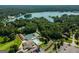 Picturesque aerial view of a lake community featuring a pool, tennis courts, and beautiful lake at 5133 Woodmond Dr, Villa Rica, GA 30180