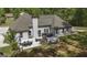 Aerial view of backyard with outdoor dining, fire pit, hot tub, and lush lawn space at 5133 Woodmond Dr, Villa Rica, GA 30180