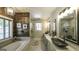 This spacious bathroom has a soaking tub, walk-in shower, and dual vanity with vessel sinks at 5133 Woodmond Dr, Villa Rica, GA 30180
