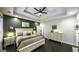 Bedroom boasts a tray ceiling, modern fan, and neutral color palette creating an inviting and peaceful retreat at 5133 Woodmond Dr, Villa Rica, GA 30180
