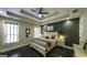 This inviting bedroom features a tray ceiling, modern fan, and a calming color palette at 5133 Woodmond Dr, Villa Rica, GA 30180
