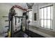 Home exercise room with weights, workout equipment, and a chandelier at 5133 Woodmond Dr, Villa Rica, GA 30180