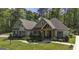 Charming single Gathering home with a manicured lawn, stone walkway and covered porch with timber detailing at 5133 Woodmond Dr, Villa Rica, GA 30180