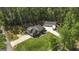 Stunning aerial view of a well-maintained home with a lush green lawn and mature trees at 5133 Woodmond Dr, Villa Rica, GA 30180