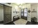 Welcoming foyer showcasing a rustic sliding barn door, wooden floors, and decorative lighting at 5133 Woodmond Dr, Villa Rica, GA 30180