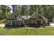 Charming home showcasing a well-manicured lawn, American flag, and inviting front porch at 5133 Woodmond Dr, Villa Rica, GA 30180
