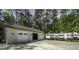 Three-car garage and RV parking showcasing ample space and convenience nestled in a wooded surrounding at 5133 Woodmond Dr, Villa Rica, GA 30180