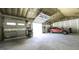Spacious garage featuring multiple doors, high ceilings and a stylish red SUV parked inside at 5133 Woodmond Dr, Villa Rica, GA 30180