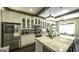 Bright kitchen with a marble countertop island, stainless appliances, and stylish cabinetry at 5133 Woodmond Dr, Villa Rica, GA 30180