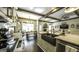 Open kitchen with island, stainless appliances, and eat-in dining area bathed in natural light at 5133 Woodmond Dr, Villa Rica, GA 30180