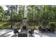 Outdoor entertaining area with a brick fireplace and a patio dining set at 5133 Woodmond Dr, Villa Rica, GA 30180