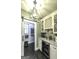 Modern pantry with custom cabinets, a drink cooler, and a decorative light fixture at 5133 Woodmond Dr, Villa Rica, GA 30180