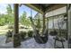 Inviting covered porch with comfortable hammock swings and stone flooring at 5133 Woodmond Dr, Villa Rica, GA 30180