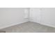Well-lit bedroom featuring neutral carpet, white walls, and a double-door closet at 383 Cantrell Drive, Dallas, GA 30157