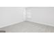 Neutral-toned bedroom with a window, white walls, and plush carpet at 383 Cantrell Drive, Dallas, GA 30157
