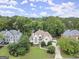 Aerial view of home with a well-manicured front yard, mature trees, and a charming neighborhood setting at 3328 Sulky Se Cir, Marietta, GA 30067