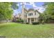 Spacious backyard featuring a large lawn, mature trees, and the rear exterior of the home with a deck at 3328 Sulky Se Cir, Marietta, GA 30067