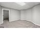 Finished basement room with neutral carpet and a doorway leading to a shelved storage area at 3328 Sulky Se Cir, Marietta, GA 30067